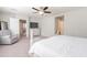 Bright main bedroom with ceiling fan, sitting area, and access to other rooms at 2469 S Sailors Ct, Gilbert, AZ 85295