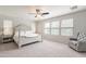 Spacious main bedroom with a ceiling fan, three windows, and a sitting chair at 2469 S Sailors Ct, Gilbert, AZ 85295