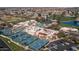 Aerial view of the community center with tennis courts, swimming pool, and picturesque landscaping at 25273 S Berry Brook Dr, Sun Lakes, AZ 85248