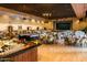 Spacious ballroom with tables, chairs, buffet stations, a stage, and decorative chandeliers at 25273 S Berry Brook Dr, Sun Lakes, AZ 85248