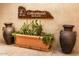 Inviting Cottonwood Bar & Grill signage with decorative pottery and a lush cactus garden at 25273 S Berry Brook Dr, Sun Lakes, AZ 85248
