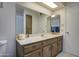 Bathroom featuring an elongated vanity with a white top and framed mirror with lots of storage at 25273 S Berry Brook Dr, Sun Lakes, AZ 85248