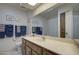 Bright bathroom with a sky light, towel racks, and vanity with framed mirror and coordinated decor at 25273 S Berry Brook Dr, Sun Lakes, AZ 85248