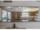Charming kitchen featuring wood cabinets, granite countertops, and a breakfast bar area at 25273 S Berry Brook Dr, Sun Lakes, AZ 85248