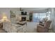 Cozy living room with a fireplace, comfortable seating, and a sliding glass door to the outside at 25273 S Berry Brook Dr, Sun Lakes, AZ 85248