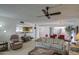Inviting living room with comfortable seating, ceiling fan, and seamless flow to dining and kitchen at 25273 S Berry Brook Dr, Sun Lakes, AZ 85248