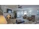 Warm and inviting living room with a fireplace, neutral decor, and a view of the backyard at 25273 S Berry Brook Dr, Sun Lakes, AZ 85248