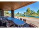 Outdoor patio with dining tables overlooking a picturesque golf course and lake at 25273 S Berry Brook Dr, Sun Lakes, AZ 85248