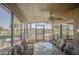 Enclosed patio with chairs and glass table offering scenic views of the community and golf course at 25273 S Berry Brook Dr, Sun Lakes, AZ 85248