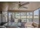 Enclosed patio with chairs and a glass table overlooking the lush green golf course at 25273 S Berry Brook Dr, Sun Lakes, AZ 85248