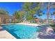 Sparkling community pool with crystal-clear water, surrounded by lounge chairs and shade umbrellas for relaxation at 25273 S Berry Brook Dr, Sun Lakes, AZ 85248