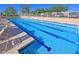 Inviting community pool with clear blue water, comfortable lounge chairs, and a secure fence at 25273 S Berry Brook Dr, Sun Lakes, AZ 85248