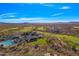 Breathtaking aerial view of a golf course and community surrounded by desert landscape and blue skies at 2550 W Pumpkin Ridge Dr, Anthem, AZ 85086