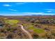 Scenic aerial view showcasing the community golf course, desert landscape, and mountain views at 2550 W Pumpkin Ridge Dr, Anthem, AZ 85086
