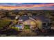 Aerial view of house featuring a private pool, fire pit, and desert landscaping at sunset at 2550 W Pumpkin Ridge Dr, Anthem, AZ 85086
