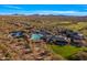 Overhead shot of a community boasting a pool, tennis courts, clubhouse, and sprawling desert landscape at 2550 W Pumpkin Ridge Dr, Anthem, AZ 85086