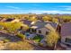 Aerial view of backyard oasis complete with pool, patio, fire pit, and beautifully landscaped grounds at 2550 W Pumpkin Ridge Dr, Anthem, AZ 85086