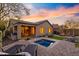 Beautiful backyard featuring a hot tub, outdoor seating, and a cozy fire pit area at 2550 W Pumpkin Ridge Dr, Anthem, AZ 85086
