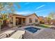 Gorgeous backyard oasis with pool, patio, outdoor grill, firepit and beautiful desert landscaping at 2550 W Pumpkin Ridge Dr, Anthem, AZ 85086