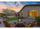 Beautiful backyard with artificial grass, fire pit, seating, and a luxurious hot tub at 2550 W Pumpkin Ridge Dr, Anthem, AZ 85086