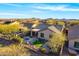 Aerial view of a home showcasing a backyard oasis with a pool, patio, and lush landscaping at 2550 W Pumpkin Ridge Dr, Anthem, AZ 85086