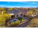 Aerial view of a backyard with a pool, patio, manicured landscaping, and a cozy fire pit at 2550 W Pumpkin Ridge Dr, Anthem, AZ 85086
