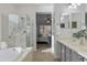 Spa-like bathroom with a glass-enclosed shower, soaking tub, and stylish vanity at 2550 W Pumpkin Ridge Dr, Anthem, AZ 85086