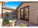 Charming courtyard entrance with lush greenery, a decorative fountain, and inviting french doors at 2550 W Pumpkin Ridge Dr, Anthem, AZ 85086