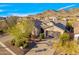 Aerial view of a desert home with low-maintenance landscaping, a multi-car garage, and picturesque mountain views at 2550 W Pumpkin Ridge Dr, Anthem, AZ 85086