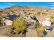 Aerial shot of a desert home with well-kept landscaping, a long driveway, and picturesque mountain views at 2550 W Pumpkin Ridge Dr, Anthem, AZ 85086