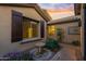 Inviting side entrance featuring decorative shutters, a charming fountain, and desert landscaping at 2550 W Pumpkin Ridge Dr, Anthem, AZ 85086