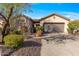 Charming single-story home with a well-maintained front yard, mature landscaping, and attached two-car garage at 2550 W Pumpkin Ridge Dr, Anthem, AZ 85086