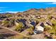 Aerial shot showcasing a home with desert landscaping, a long driveway, and scenic mountain views at 2550 W Pumpkin Ridge Dr, Anthem, AZ 85086