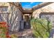 Inviting front entrance with a wrought iron gate, desert plants, and a cozy courtyard at 2550 W Pumpkin Ridge Dr, Anthem, AZ 85086
