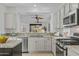 Bright kitchen featuring granite countertops, stainless steel appliances, and seamless flow to the living area at 2550 W Pumpkin Ridge Dr, Anthem, AZ 85086