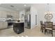Well-lit kitchen with stainless steel appliances, a center island, and an adjacent dining area at 2550 W Pumpkin Ridge Dr, Anthem, AZ 85086
