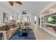 Open-concept living room with a fireplace, comfortable seating, and seamless access to the kitchen at 2550 W Pumpkin Ridge Dr, Anthem, AZ 85086