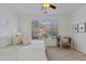Serene bedroom with a large window offering natural light, complemented by a cozy sitting area at 2550 W Pumpkin Ridge Dr, Anthem, AZ 85086