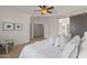 Bright main bedroom featuring neutral tones, and a sliding barn door to the ensuite bathroom at 2550 W Pumpkin Ridge Dr, Anthem, AZ 85086