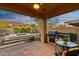 Covered patio featuring an outdoor kitchen, built-in grill, seating, and a view of the pool at 2550 W Pumpkin Ridge Dr, Anthem, AZ 85086