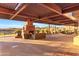 Spacious covered patio featuring a stone fireplace, comfortable seating, and stunning mountain views at 2550 W Pumpkin Ridge Dr, Anthem, AZ 85086