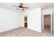 Bedroom with neutral carpet, fan, and a view into the bathroom and closet at 2624 E La Costa Dr, Chandler, AZ 85249