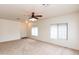 Bright living room with neutral carpet, ceiling fan, and large windows with blinds at 2624 E La Costa Dr, Chandler, AZ 85249
