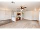 Open-concept living space with carpet, tile, and kitchen island with breakfast bar seating at 2624 E La Costa Dr, Chandler, AZ 85249