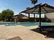 Community pool with ample space for swimming and lounging with mature landscaping for a relaxing environment at 2624 E La Costa Dr, Chandler, AZ 85249