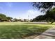 Community sand volleyball court and well-manicured lawn areas for outdoor recreation and fitness at 2624 E La Costa Dr, Chandler, AZ 85249