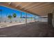 A covered patio has access to the backyard that has fresh gravel and young plants at 2634 N 52Nd Ave, Phoenix, AZ 85035