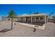 The backyard with covered patio features new gravel and plants for low maintenance at 2634 N 52Nd Ave, Phoenix, AZ 85035