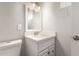 This bathroom features a single sink, mirror, white cabinets and lighting at 2634 N 52Nd Ave, Phoenix, AZ 85035