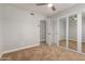 This bedroom features carpet floors, an open closet, and neutral paint at 2634 N 52Nd Ave, Phoenix, AZ 85035